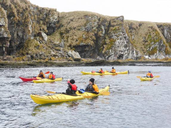 Nosso grupo de caiaque rema ao lado das encostas de Prion Island, na Geórgia do Sul. Nós estamos em primeiro plano, em um caiaque duplo